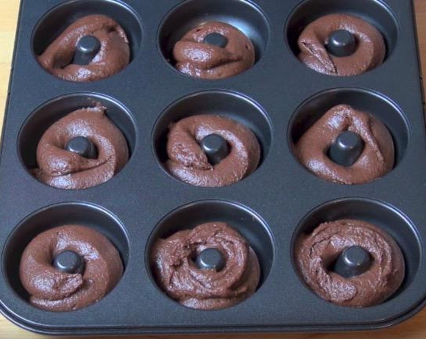 step 2 Put the batter in a ziploc bag and force it to one corner, snipe of the corner. Take a donut tray and pipe the batter into each donut mold. Preheat the oven to 180 degrees C (350 degrees F) and cook for about 20 minutes. Allow the donuts to cool for 5 minutes in the tin then transfer them to a wire rack to cool off completely.