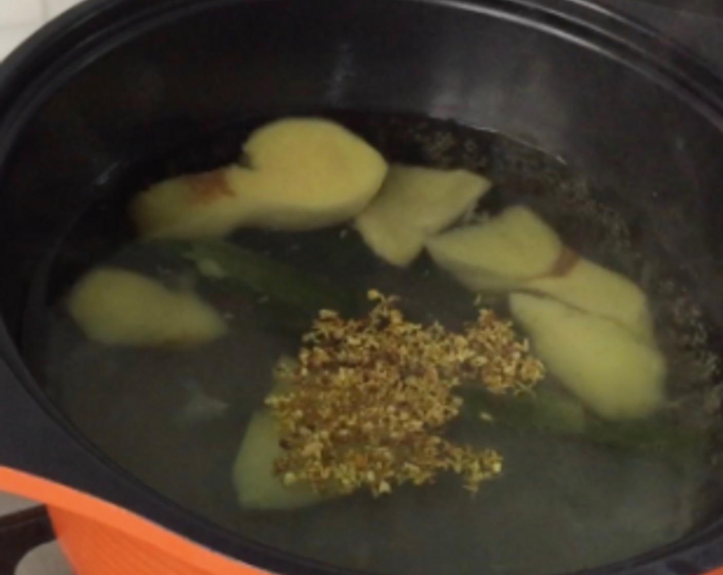 step 6 Then add in Granulated Sugar (4 Tbsp) and sweet Dried Osmanthus Flowers (1 tsp). Boil for another 5 minutes over medium heat.