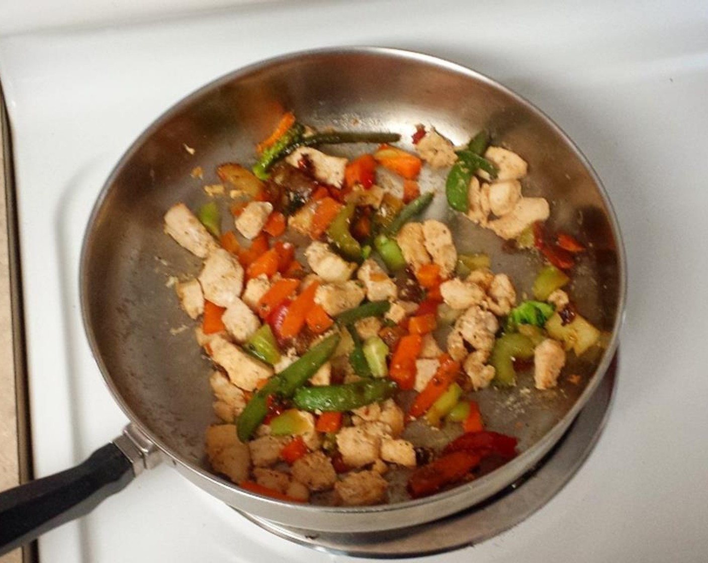 step 1 Grease a deep frying pan or wok with Olive Oil Cooking Spray (as needed). Chop Boneless, Skinless Chicken Breasts (2) into cubes, then cook with Garlic Powder (2 tsp), Ground Cumin (1 tsp), Seasoned Salt (1 tsp), and Ground Black Pepper (1 tsp) until chicken is white all through.