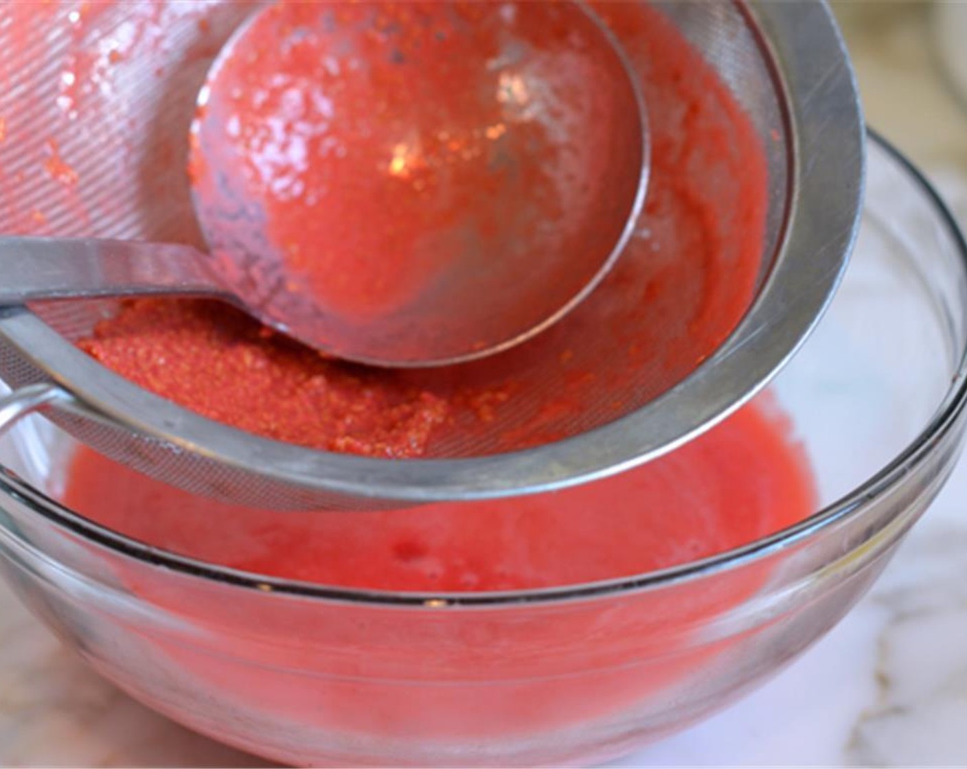 step 3 Pass the mixture through a fine sieve into a large bowl to strain out the seeds.