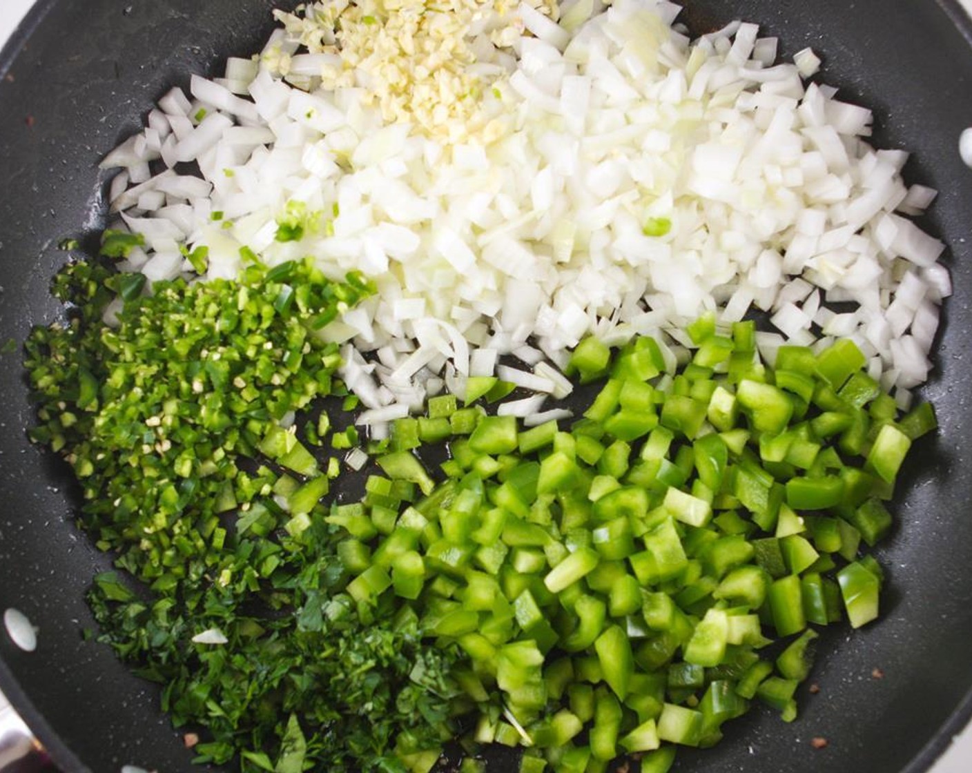 step 2 Add the Extra-Virgin Olive Oil (4 Tbsp) to the skillet. Add the Yellow Onion (1), Green Bell Pepper (1), Garlic (4 cloves), Italian Flat-Leaf Parsley (4 Tbsp) and Jalapeño Peppers (2) (if using) and cook over medium heat, stirring occasionally, until onions are soft and fragrant (about 5 minutes).