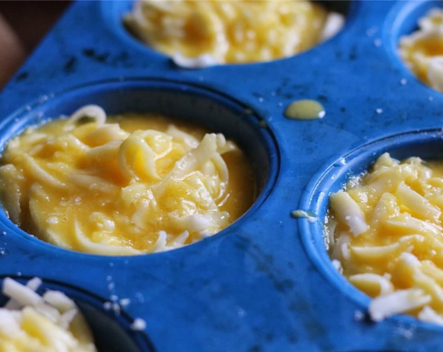 step 6 Melt Butter (4 Tbsp). Whisk together Eggs (3) and melted butter. Pour egg mixture evenly into each muffin cup.  Push the eggplant and cheese down a little to mix the egg mixture evenly through the layers.
