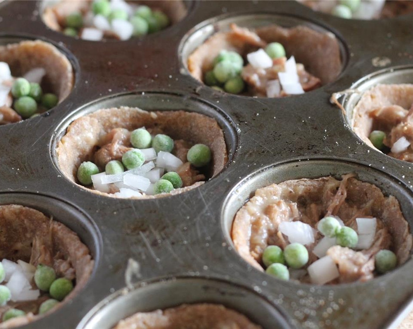 step 11 Sprinkle with a teaspoon (or desired amount) each of White Onion (1), Frozen Green Peas (4 Tbsp), and Frozen Corn Kernels (4 Tbsp). Divide the remaining Gravy (1 1/2 cups) evenly over the top, around 1 tablespoon each.