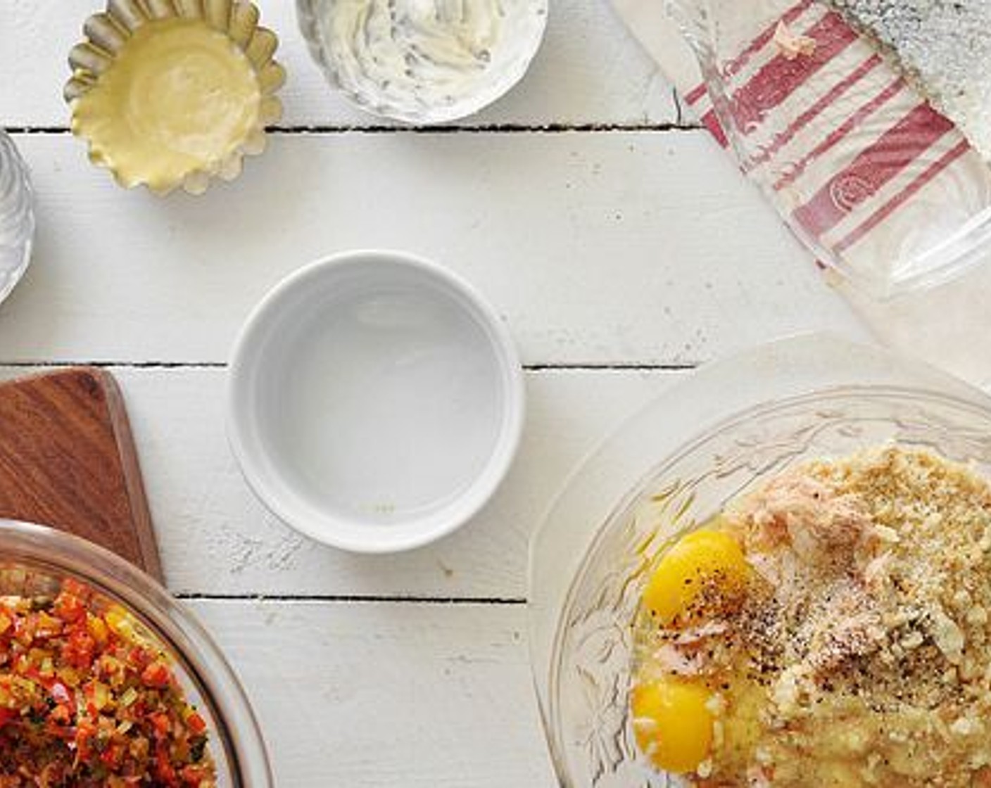 step 8 Separate the salmon from it’s skin and flake it into a large mixing bowl. Add the Mayonnaise (1/2 cup), Dijon Mustard (1 Tbsp), bread crumbs, cooked veggies, Large Eggs (2), and a bit more salt and pepper.