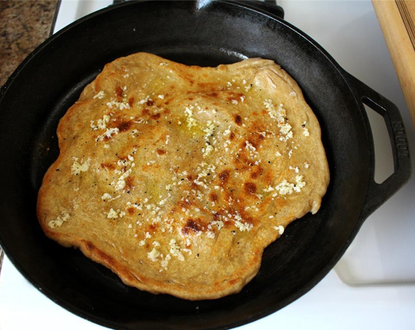 step 1 Add Pizza Crust (1) to a skillet. Cook one side for 2 to 3 minutes, then flip. Top crust with Olive Oil (as needed) and grated or shredded Cheddar Cheese (1/2 cup) and Parmesan Cheese (1/2 cup).