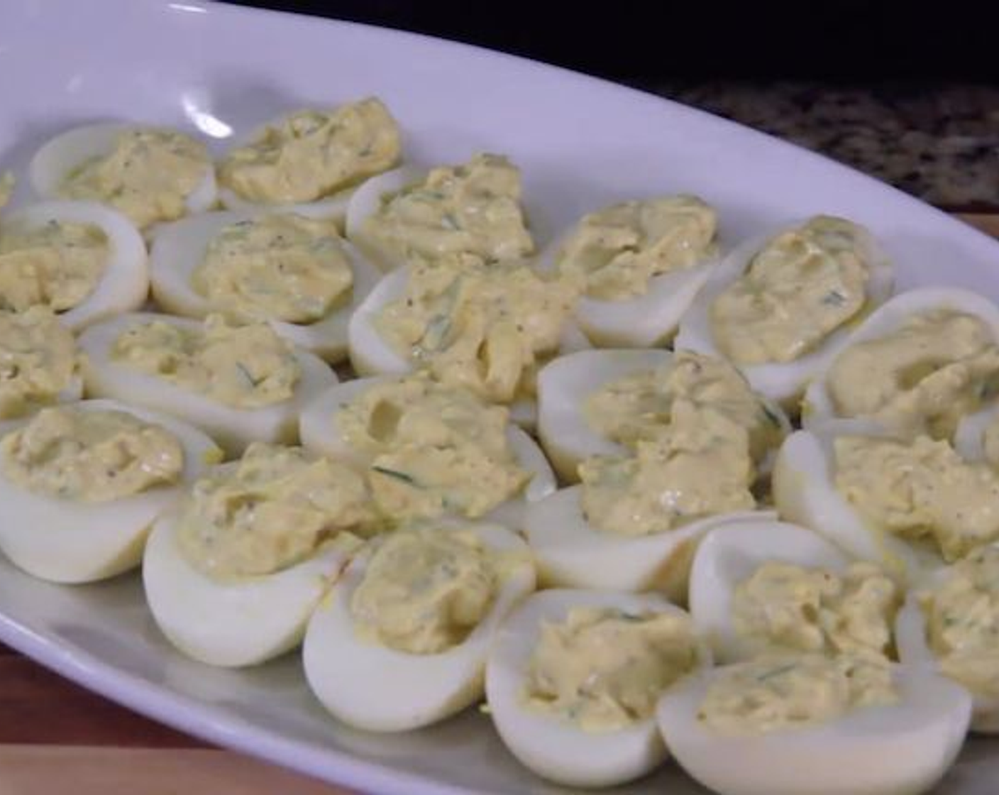 step 5 Using either a piping bag with your largest tip, or a teaspoon, fill each egg white with about 2-3 tsp of the yolk mixture.