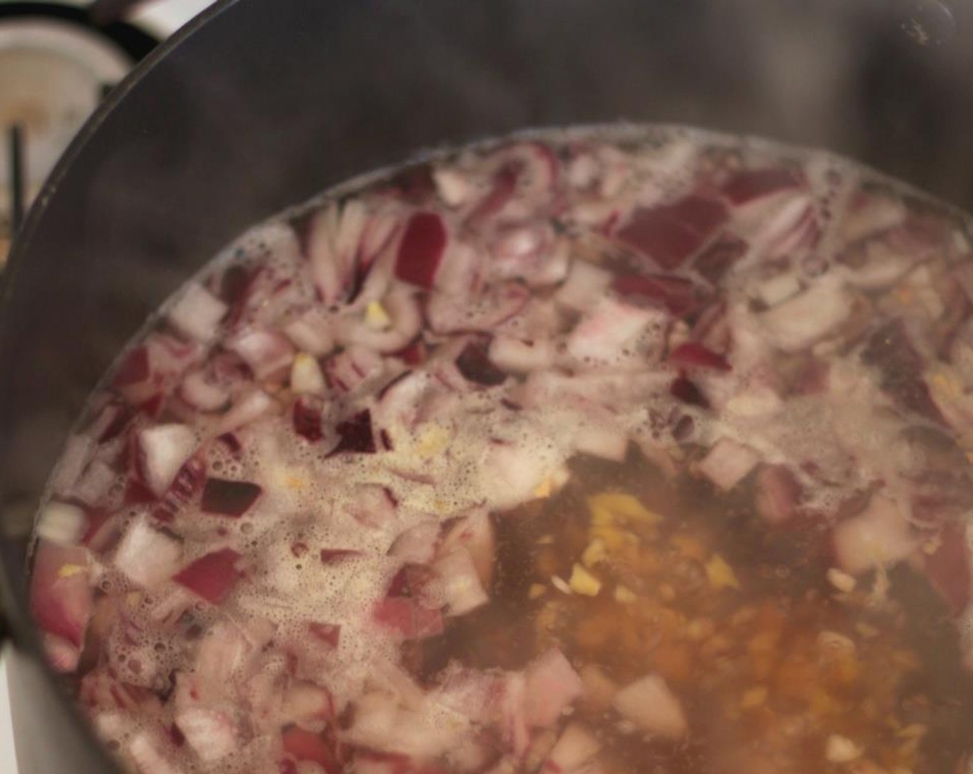 step 3 In a large pot, bring Low-Sodium Vegetable Stock (6 cups) to a boil. Stir in the onion, garlic, ginger, and Salt (1 tsp) and cook for 20 minutes.