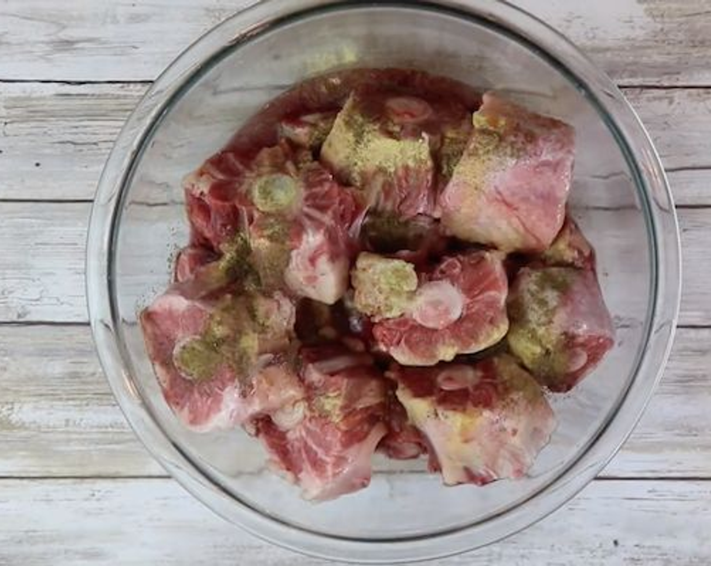 step 1 Rinse Oxtail (1) in water. Marinade oxtails with the Distilled White Vinegar (4 Tbsp), Red Wine (4 Tbsp), Adobo Seasoning (2 Tbsp), Garlic (1 tsp), and Salt (1/2 tsp). Marinade in the fridge overnight if possible or at least 2 hours.