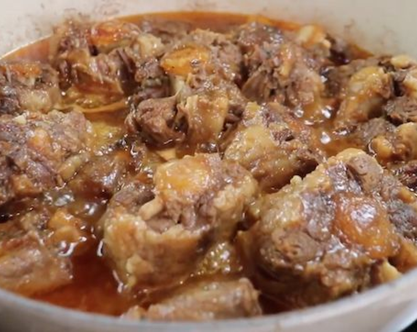step 3 When you feel that the oxtail is beginning to feel tender add Onion (1/2), Green Bell Pepper (1), Red Bell Pepper (1), Pitted Green Olives (4 Tbsp), and Tomato Sauce (2 Tbsp). Stir well and continue to simmer for 20-30 minutes until you feel it is tender enough for your liking, especially the bigger pieces.