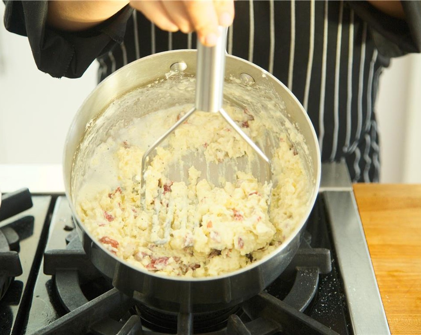 step 11 Using a potato masher, smash potatoes with Butter (4 Tbsp), Sour Cream (2 Tbsp), Whipping Cream (2 Tbsp), Salt (1/2 tsp), and Ground Black Pepper (1/4 tsp). Cover and heat.