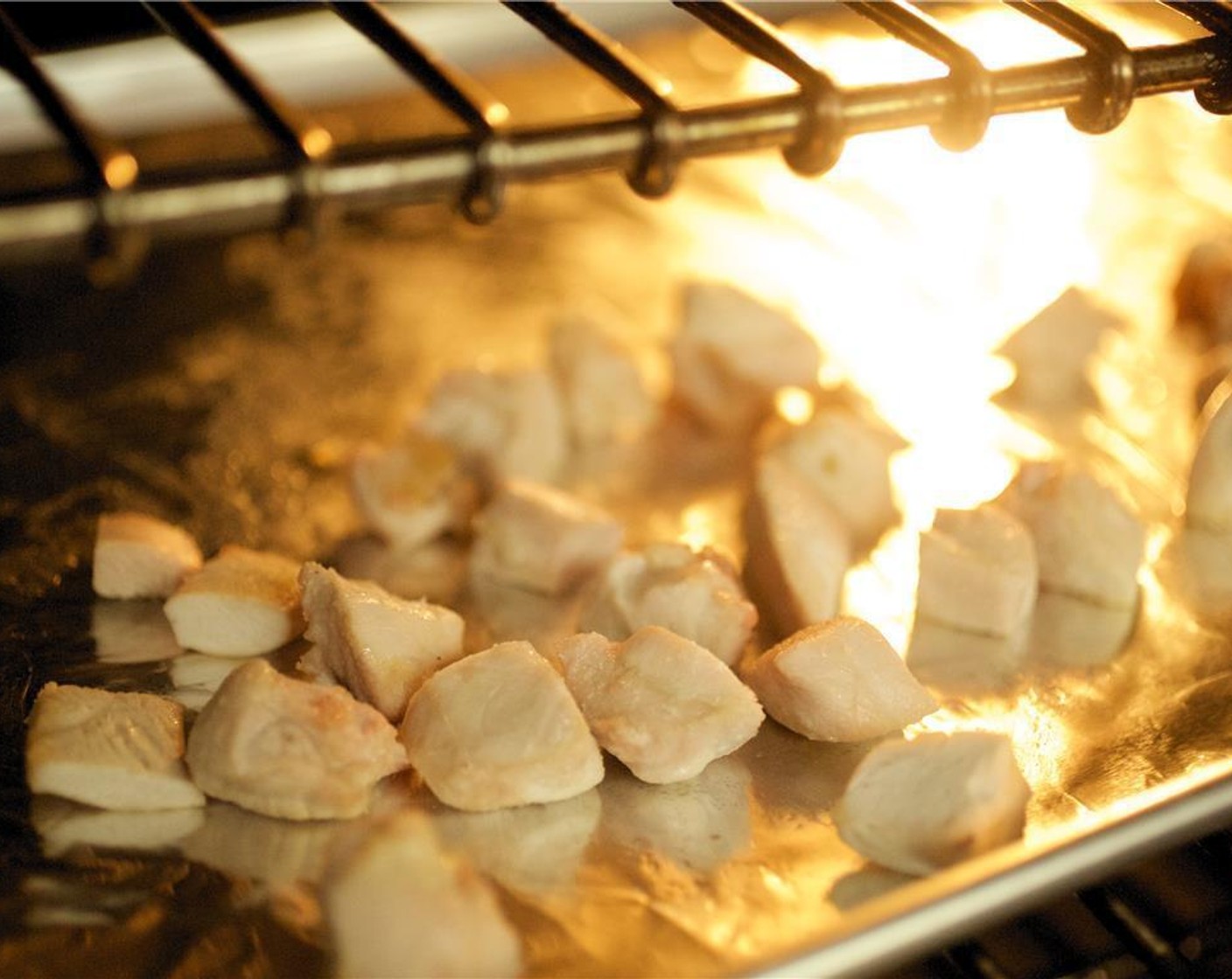 step 6 Pat dry the Chicken Breasts (2) and cut into 1 inch cubes. On a baking sheet lined with foil, toss the chicken with 1 tablespoon of Corn Starch (1 Tbsp). Place in oven and roast for 13 to 15 minutes.