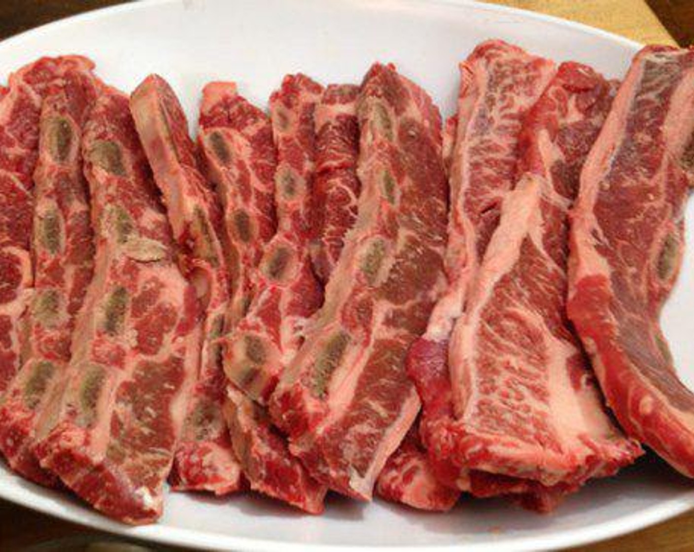 step 1 Cut Beef Short Ribs (6) about 1/3” thick from the chuck flanken. Season the short ribs with All-Purpose Spice Rub (to taste) on both sides. Next spread Dark Brown Sugar (4 Tbsp) evenly on all sides.