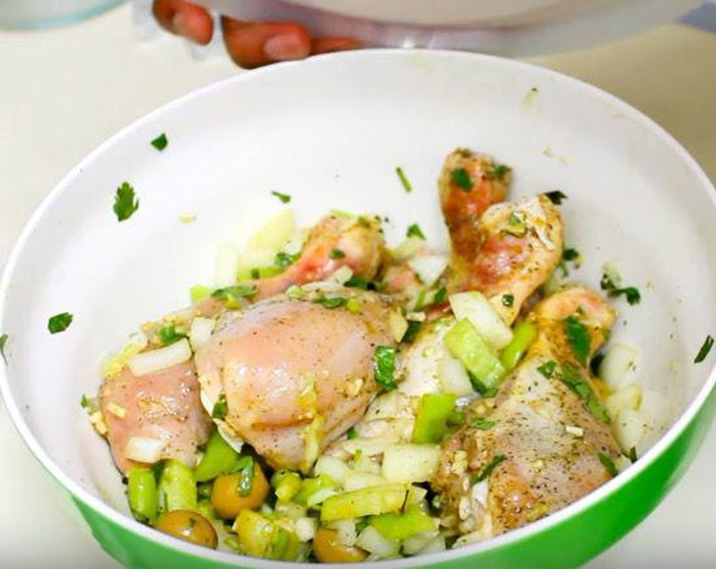 step 1 In a mixing bowl, squeeze the Lime (1) over the Chicken Drumsticks (5). Add Dried Oregano (1/2 tsp), Ground Black Pepper (1/8 tsp), Fresh Cilantro (2 1/2 Tbsp), Chicken Bouillon Powder (1 pckg), Yellow Onion (1), Garlic (3 cloves), Cubanelle Pepper (1/2), and Manzanilla Olives (4 Tbsp).