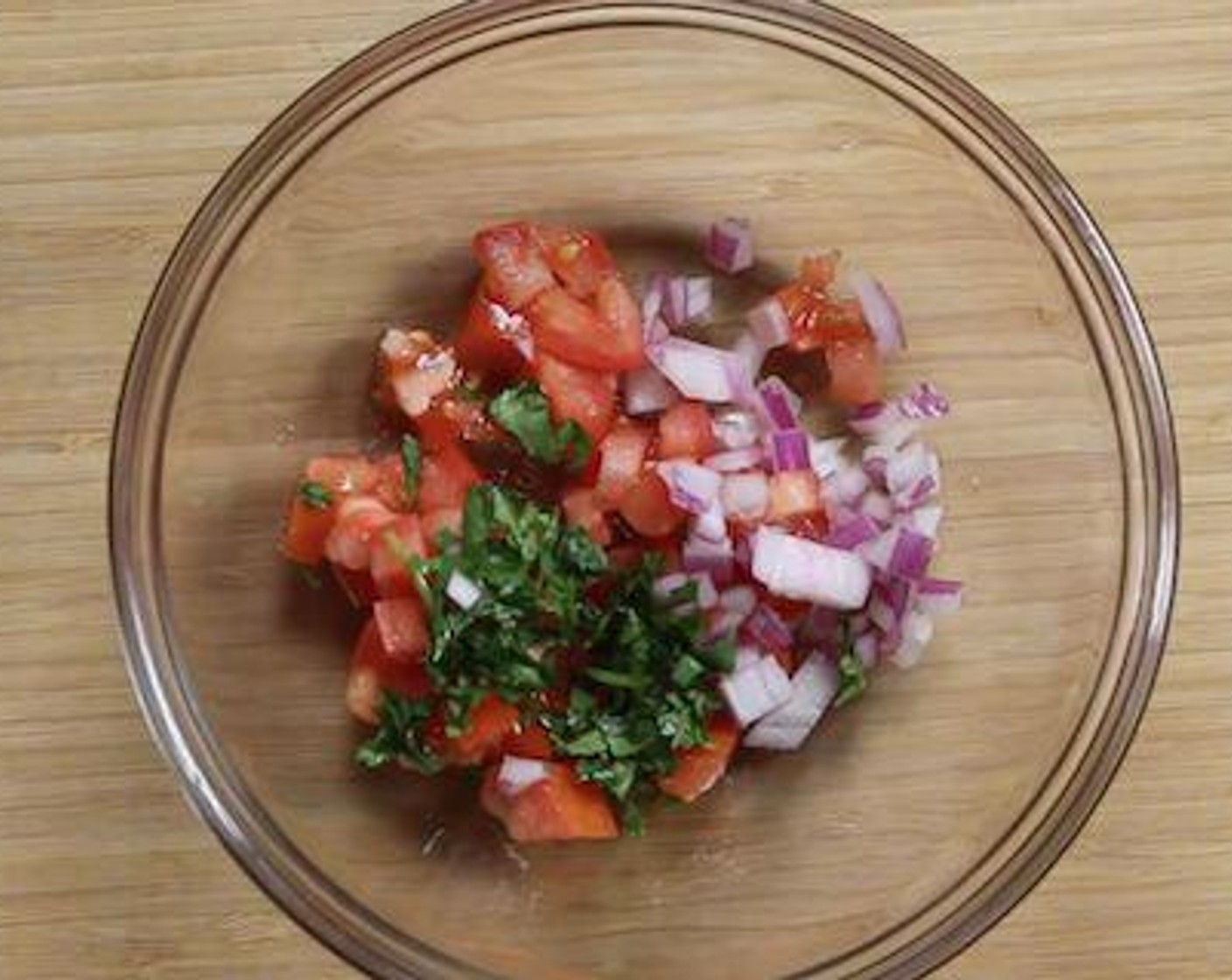step 2 For the salsa, into a bowl add Tomatoes (4 Tbsp), Red Onion (1 Tbsp), Fresh Parsley (1 tsp), and Lime (1/2).