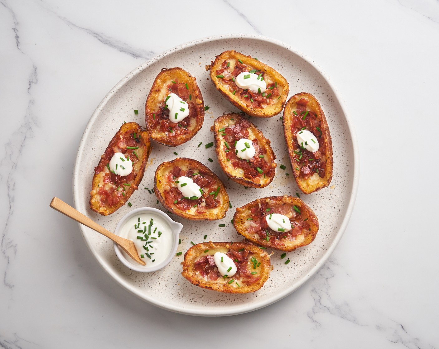step 8 Top each potato with a dollop of Sour Cream (1 cup) and sprinkle with Scallions (3 stalks). Enjoy it fresh out of the oven!