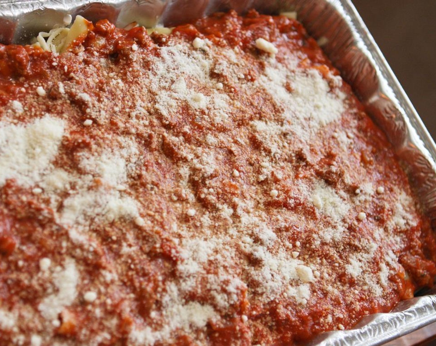 step 10 Add the remaining sauce mixture and top with the Parmesan Cheese (4 Tbsp). Bake for 30 minutes in the preheated oven.