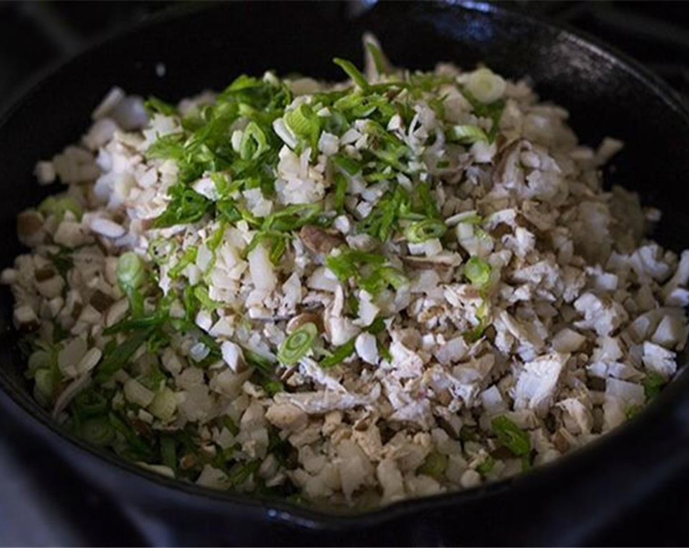 step 7 Reheat the pan you used to cook the chicken, adding more oil if needed. Add the Garlic (1 clove) Scallion (1 bunch), Water Chestnuts (1 cup), and Shiitake Mushrooms (8). Sauté about 3 minutes or until warmed through.