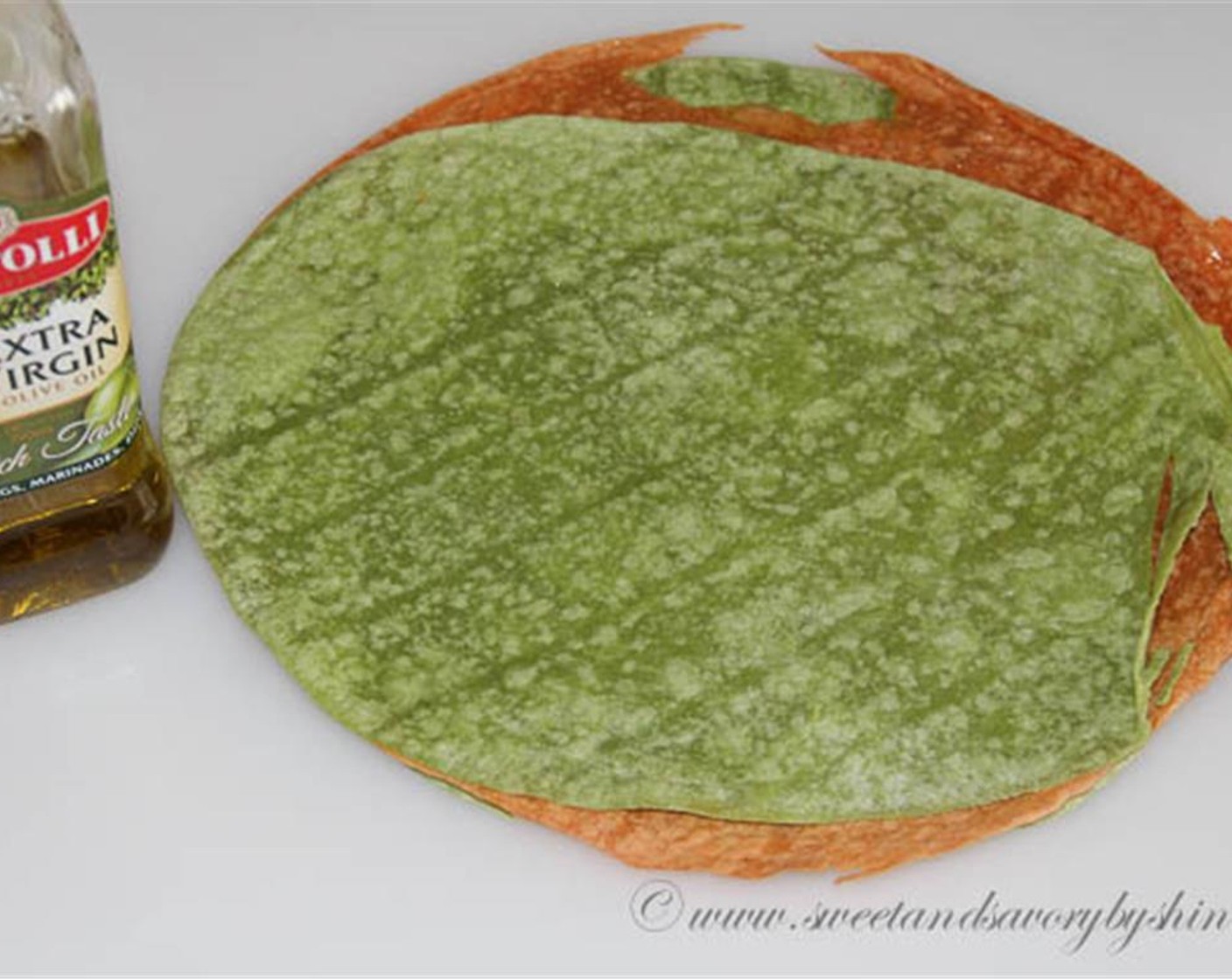 step 1 Evenly spread a tablespoon of Olive Oil (4 Tbsp) over each Flour Tortillas (4). Stack the wraps on top of each other. This will oil both sides of the wrap.