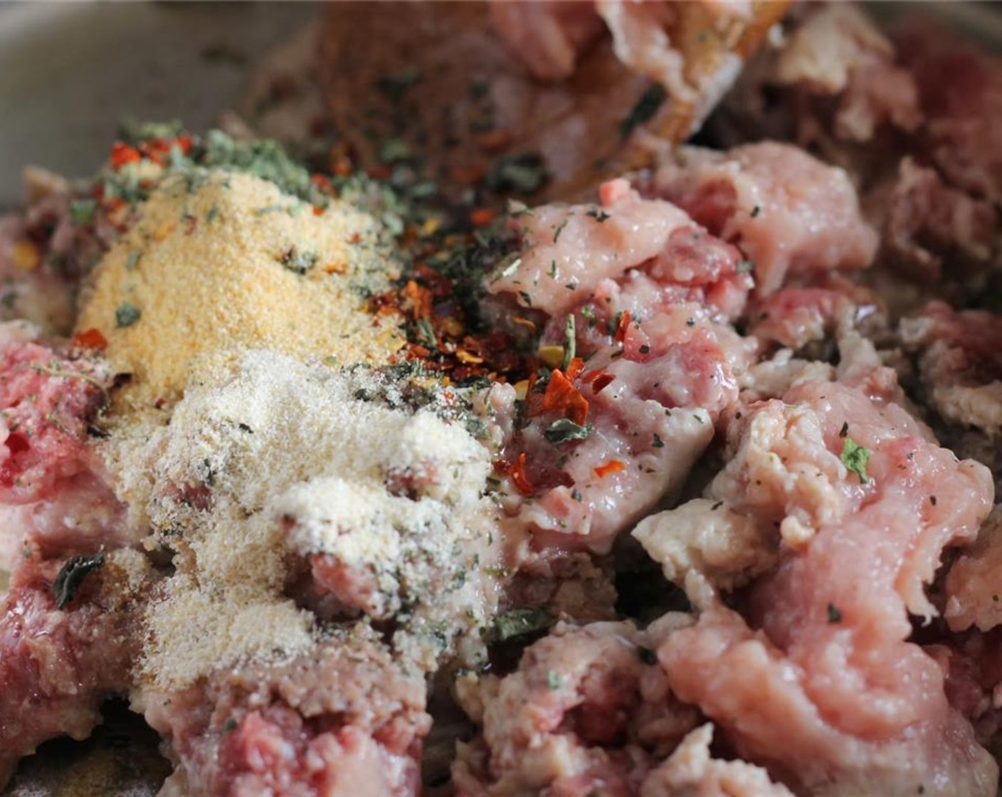 step 9 Make the sauce: Pour Olive Oil (2 Tbsp) into pan, add Lean Ground Beef (1 lb), Dried Basil (1/2 tsp), Garlic Powder (1/2 tsp), Onion Powder (1/2 tsp), Crushed Red Pepper Flakes (1/2 tsp), Salt (1/2 tsp), and Ground Black Pepper (to taste).