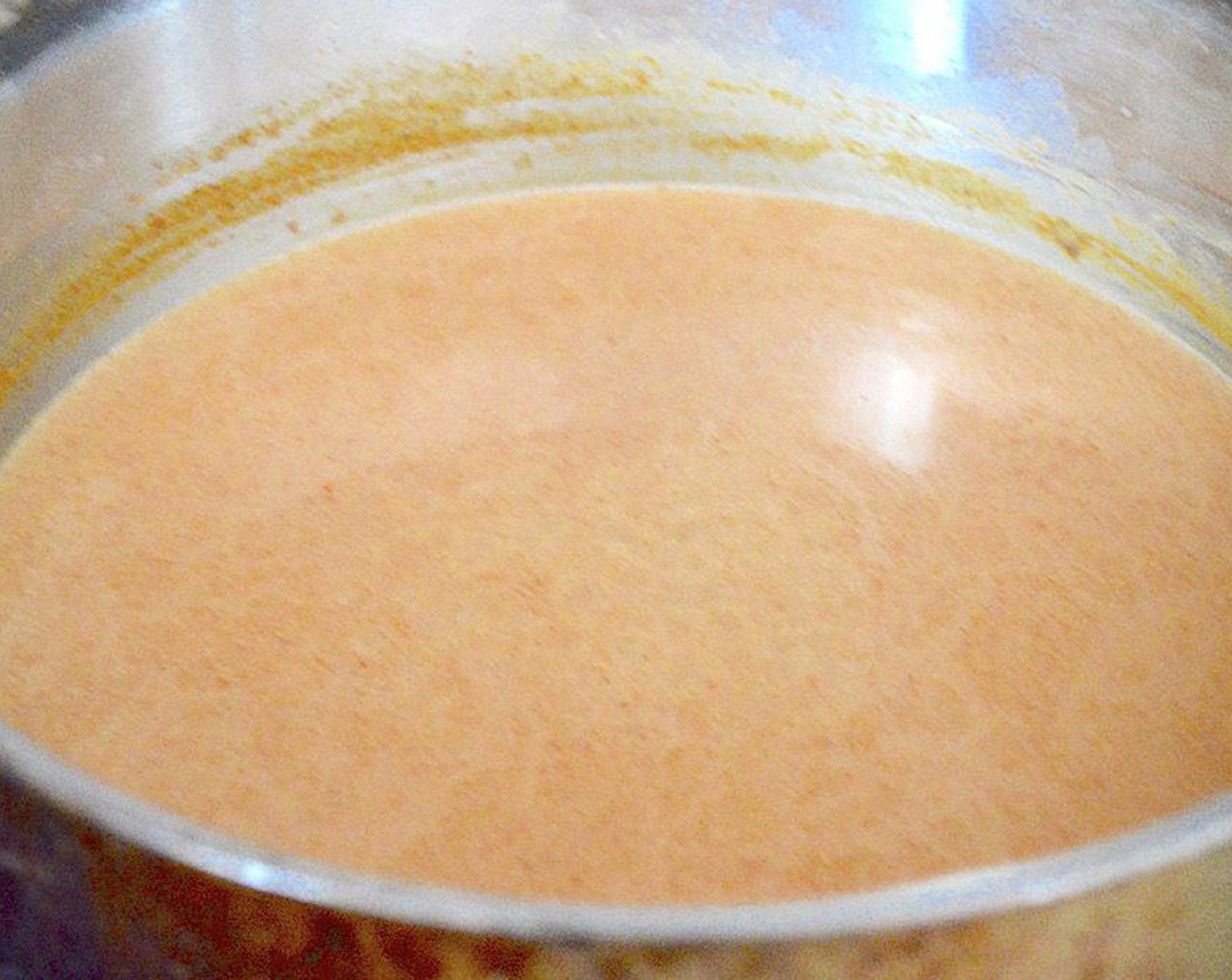 step 5 Get out a large skillet with deep sides and pour the Coconut Milk (1 3/4 cups) in it. Heat it up over medium high heat just until it starts to bubble. Add the Thai Red Curry Paste (1 Tbsp), Almond Butter (1 Tbsp), Salt (1 pinch) and Garlic Powder (1 pinch). Let it gently simmer for 15 minutes, stirring often.