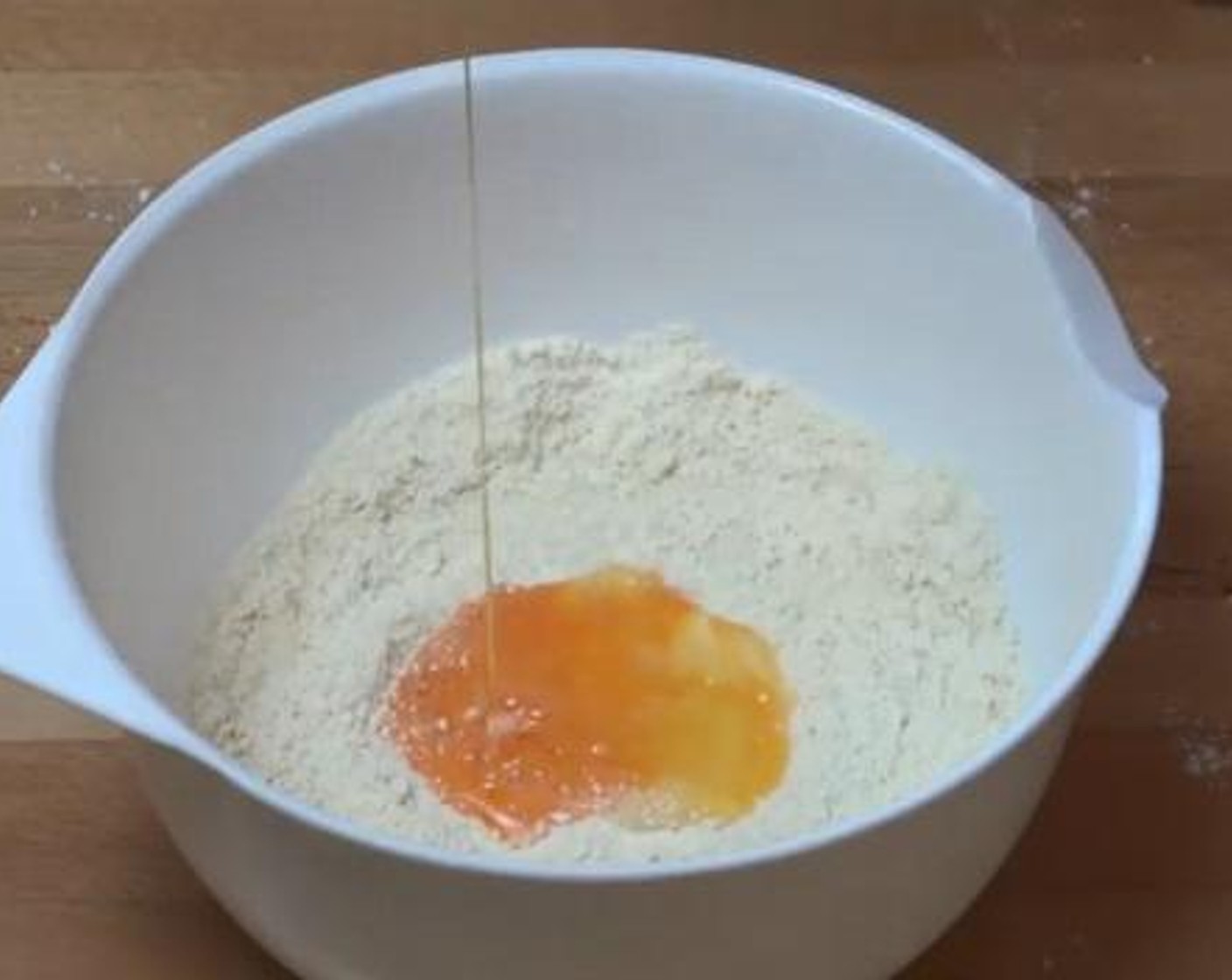 step 1 Into a mixing bowl, add and mix the Self-Rising Flour (1 cup), and Butter (2 Tbsp). Then add in the Salt (1 pinch), Milk (4 Tbsp), and Egg (1), and combine everything together.
