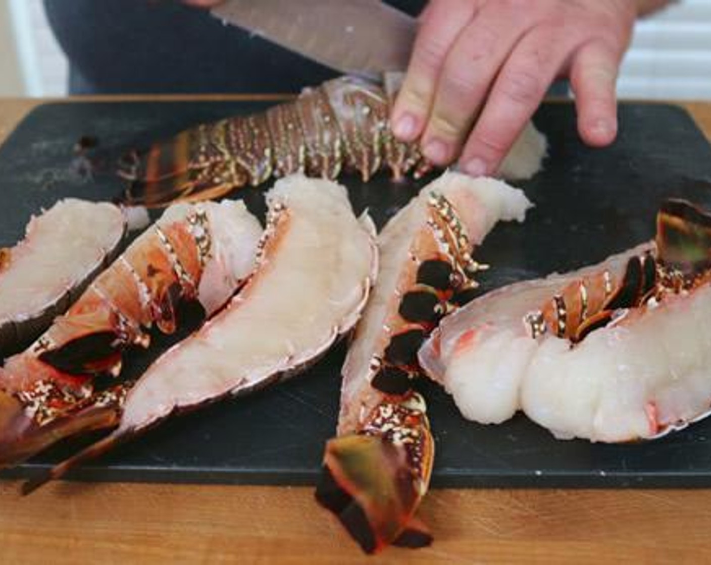 step 2 Split Lobster Tails (4) in half length-wise and season with Kosher Salt (1 Tbsp), Freshly Ground Black Pepper (1 Tbsp), and Olive Oil (4 Tbsp).