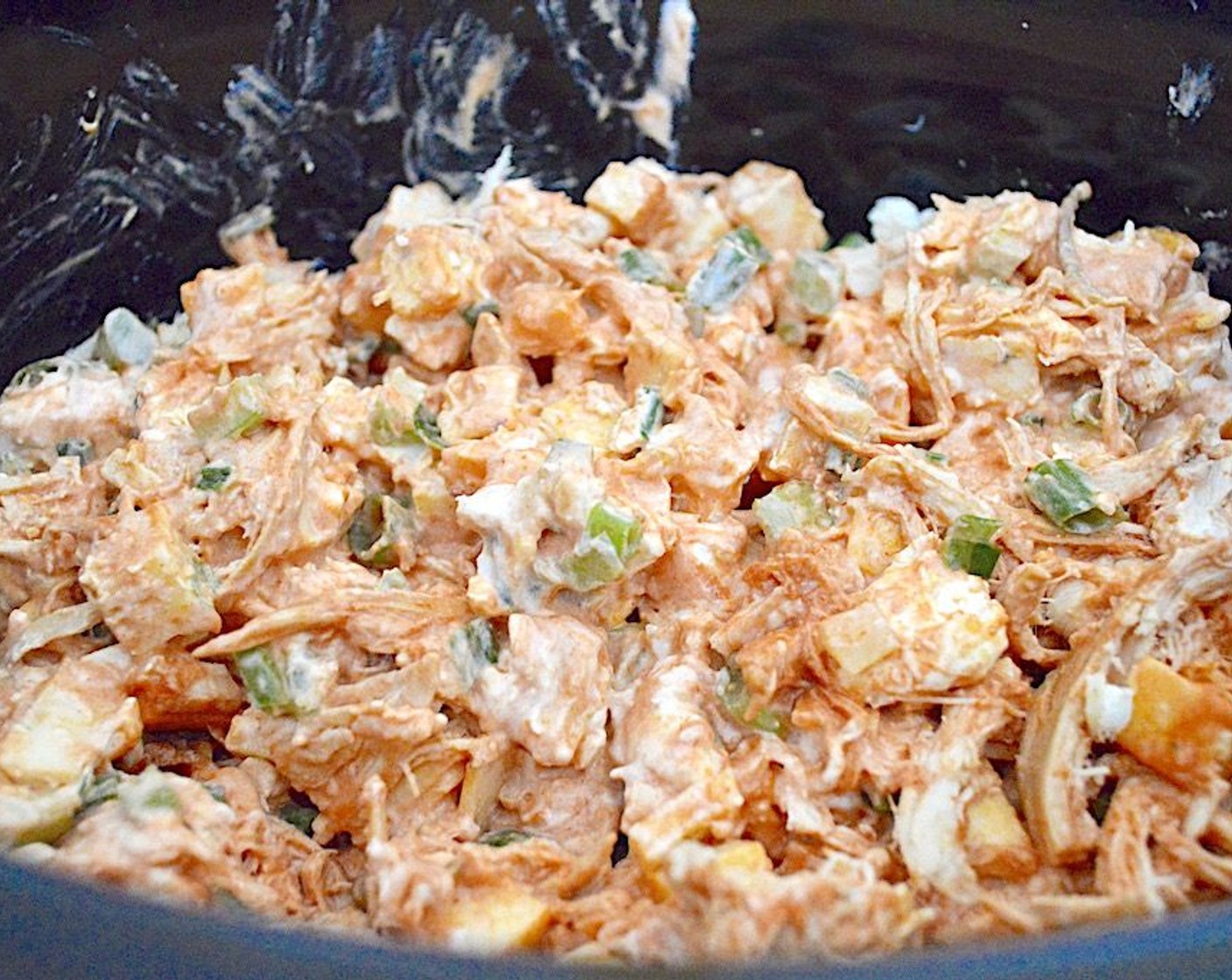 step 1 Combine Rotisserie Chicken (3 cups), Frank's® RedHot® Buffalo Sauce (1 cup), Pepper Jack Cheese (10 slices), Cream Cheese (1 cup), Scallions (4 stalks), Celery (2 stalks), Salt (1 pinch), and Garlic Powder (1/2 tsp) in a crock pot and give it a stir.