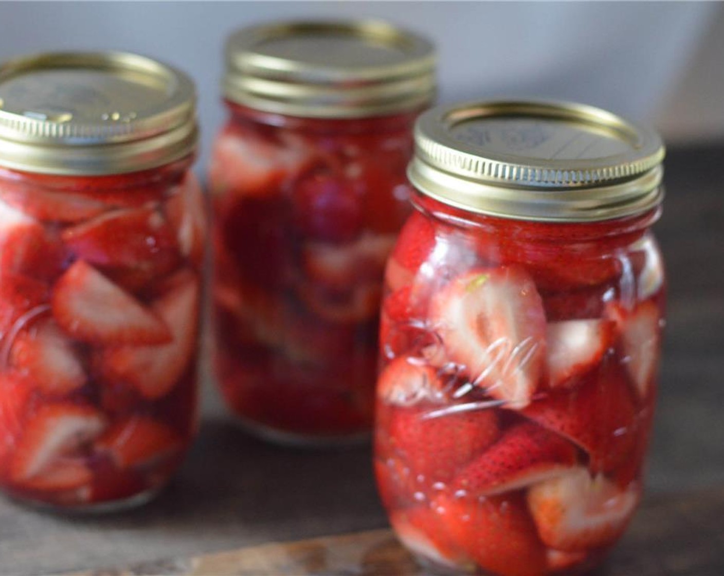 step 3 Fill mason jars with strawberries, packing them in there. Pour Vodka (3 cups) over strawberries, filling to just below the rim.
