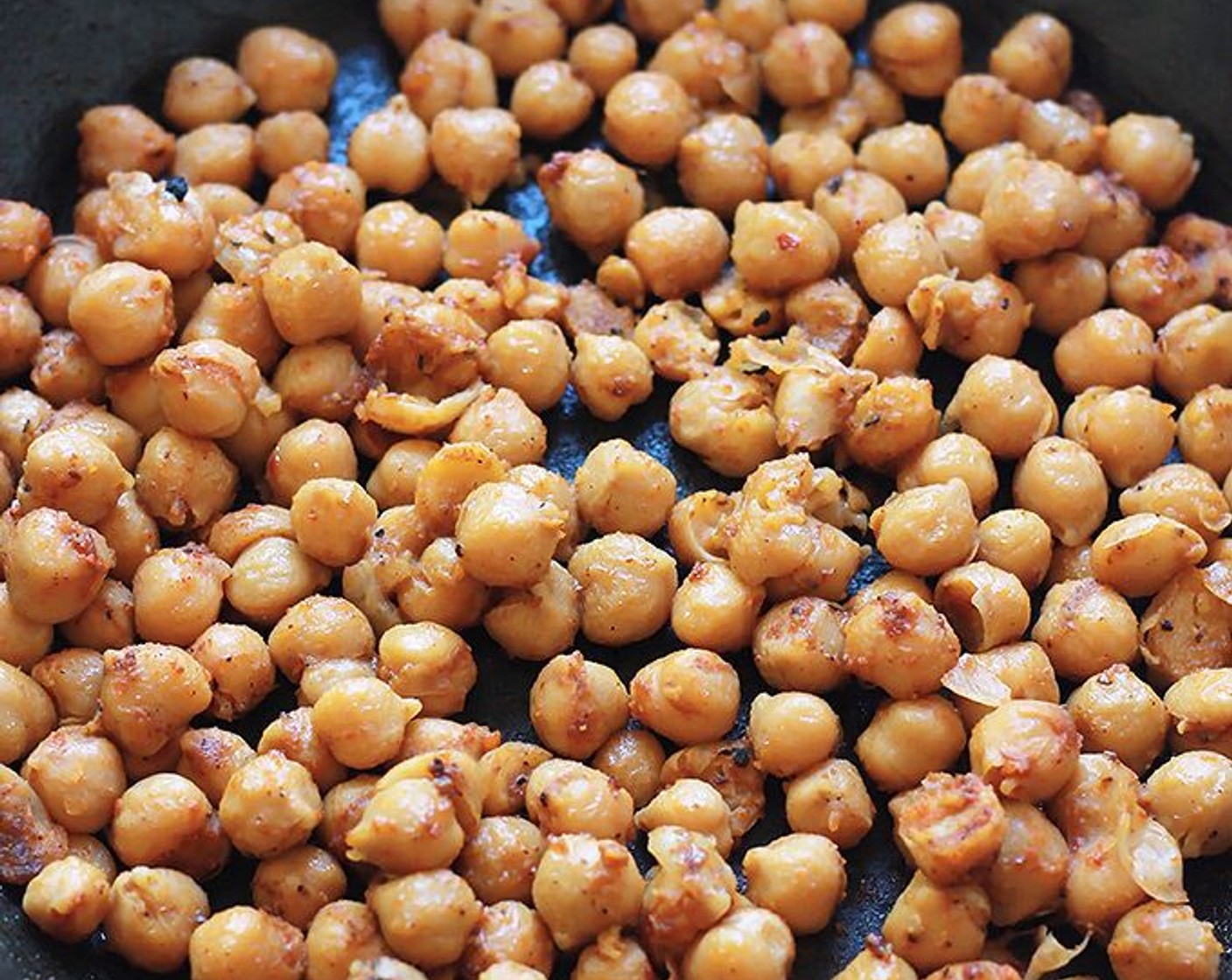 step 4 After sauteing the tofu, add a bit more oil to the pan. Add Taco Seasoning (1 packet) to the pan and sprinkle on Chickpeas (2 cans). Saute the chickpeas until well coated and heated.