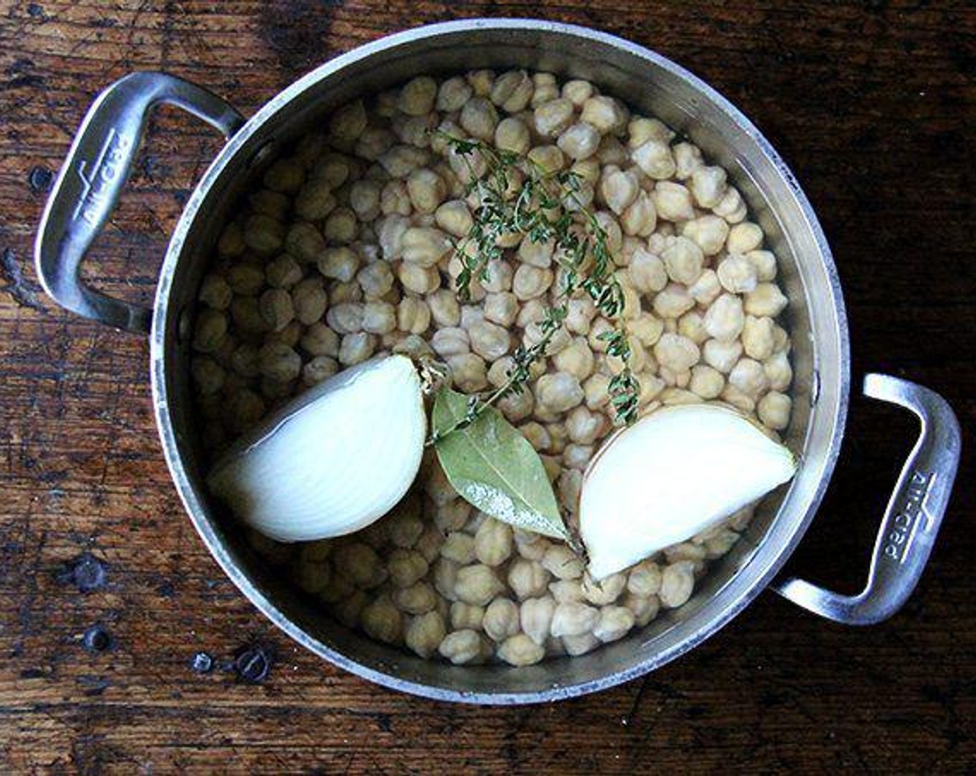 step 2 Drain chickpeas, rinse and place in a pot with the Onion (1), Fresh Thyme (3 sprigs), Garlic (1 clove), Bay Leaf (1) and Kosher Salt (1 tsp). Cover with water by three inches.