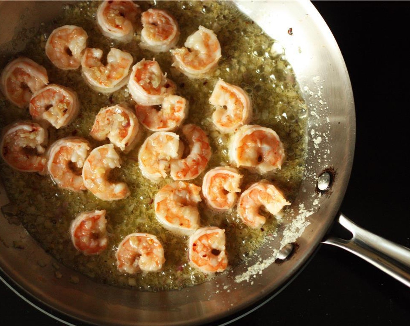 step 4 Add the shrimp, Salt (1/2 tsp) and Ground Black Pepper (1/2 tsp) to the frying pan and sauté for 3-4 minutes until the shrimp is pink and opaque on both sides.