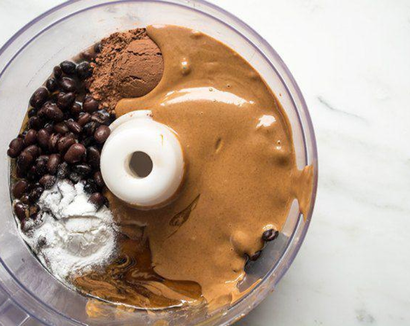 step 2 Combine Canned Black Beans (2 1/3 cups), Unsweetened Cocoa Powder (2 Tbsp), Vanilla Extract (1 Tbsp), Peanut Butter (2/3 cup), Honey (1/3 cup), and Baking Powder (1 tsp) in the container of a food processor. Process mixture until very smooth.