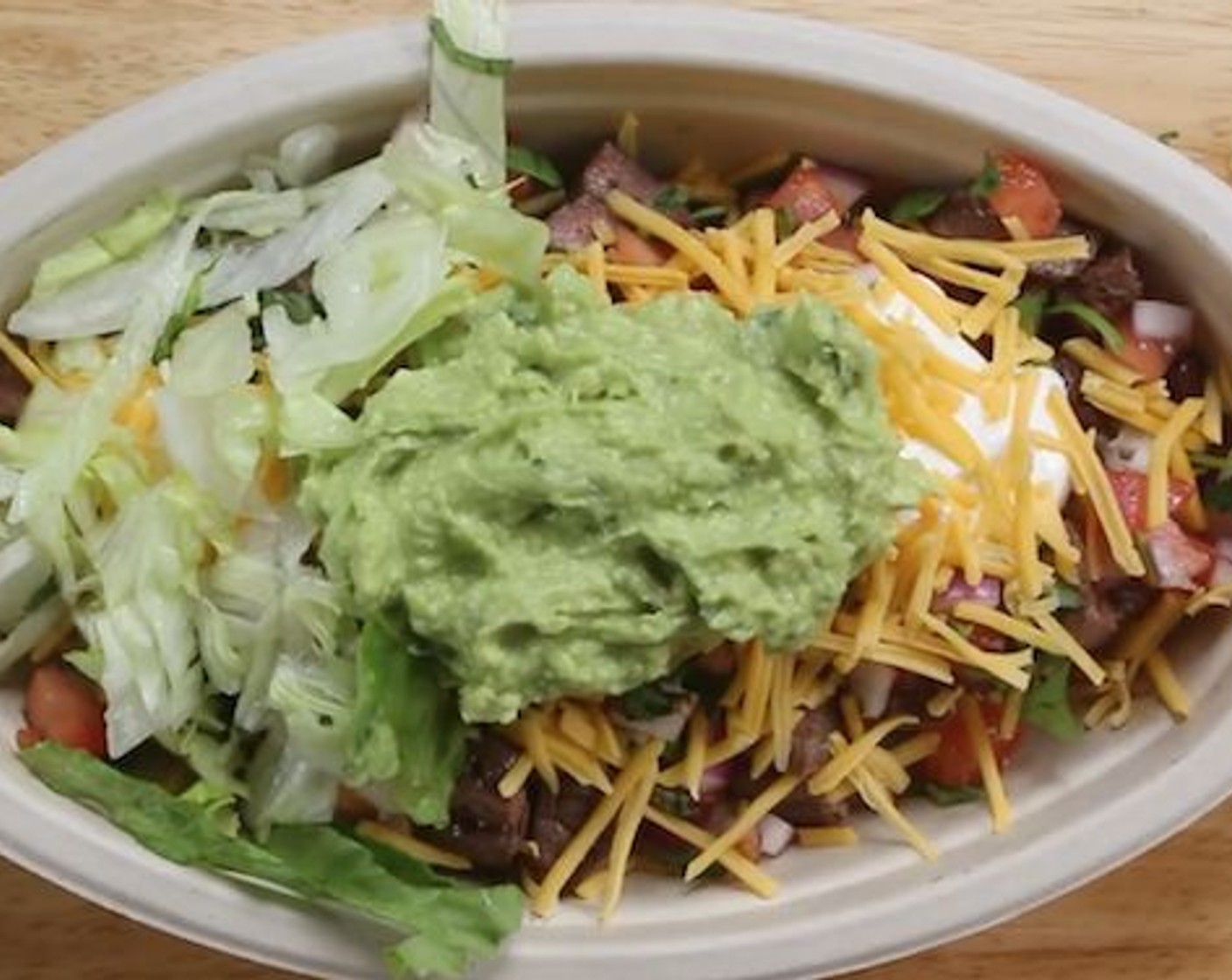 step 6 To assemble the steak bowl add 1/2 cup of the cilantro rice, Canned Black Beans (1/2 cup), Beef Steak Chunks, Salsa, Sour Cream (1 Tbsp), Cheddar Cheese (4 Tbsp), 1/2 cup of the guacamole and finish with Shredded Iceberg Lettuce (1/2 cup). Serve and enjoy!