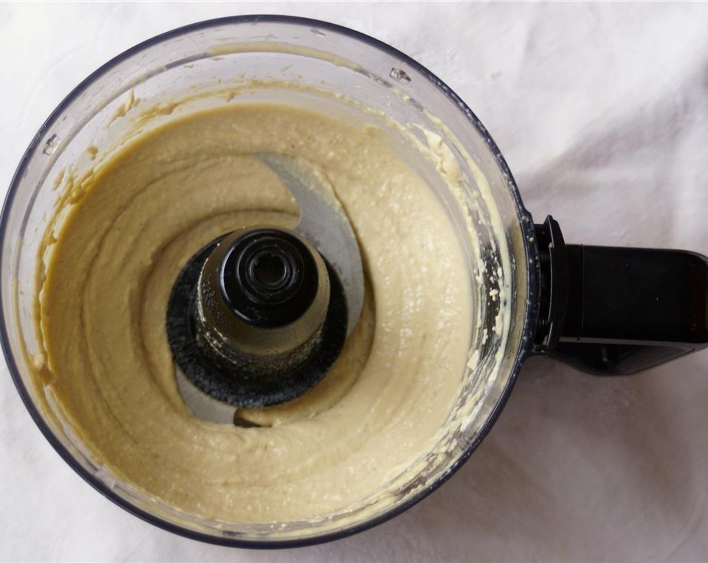 step 1 Add the Tahini (4 Tbsp), juice from Lemon (1) and juice from Orange (1) to the base of a food processor. Process for a minute, or until it turns into a fluffy paste.