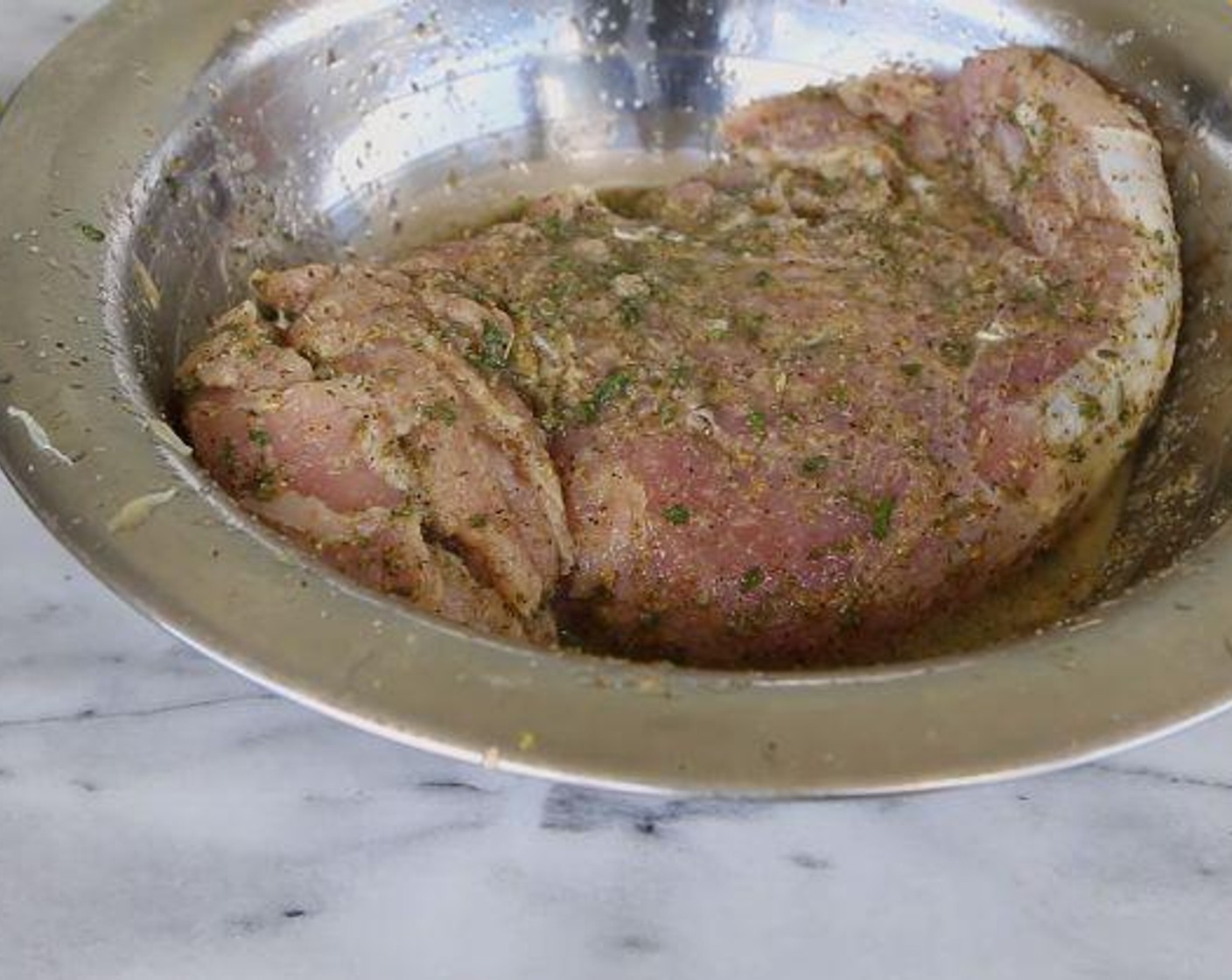 step 1 With a fork, poke some holes into the Pork Tenderloin (1 lb). In a bowl, place the pork and add the Garlic Powder (1 tsp), Onion Powder (1 tsp), Dried Oregano (1 tsp), Salt (1 tsp), Ground Black Pepper (to taste), Dried Parsley (1 tsp), Dried Thyme (1/2 tsp), the juice from the Lime (1) and Sunkist Orange (1). Cover and let marinate in the fridge for at least 30 minutes.
