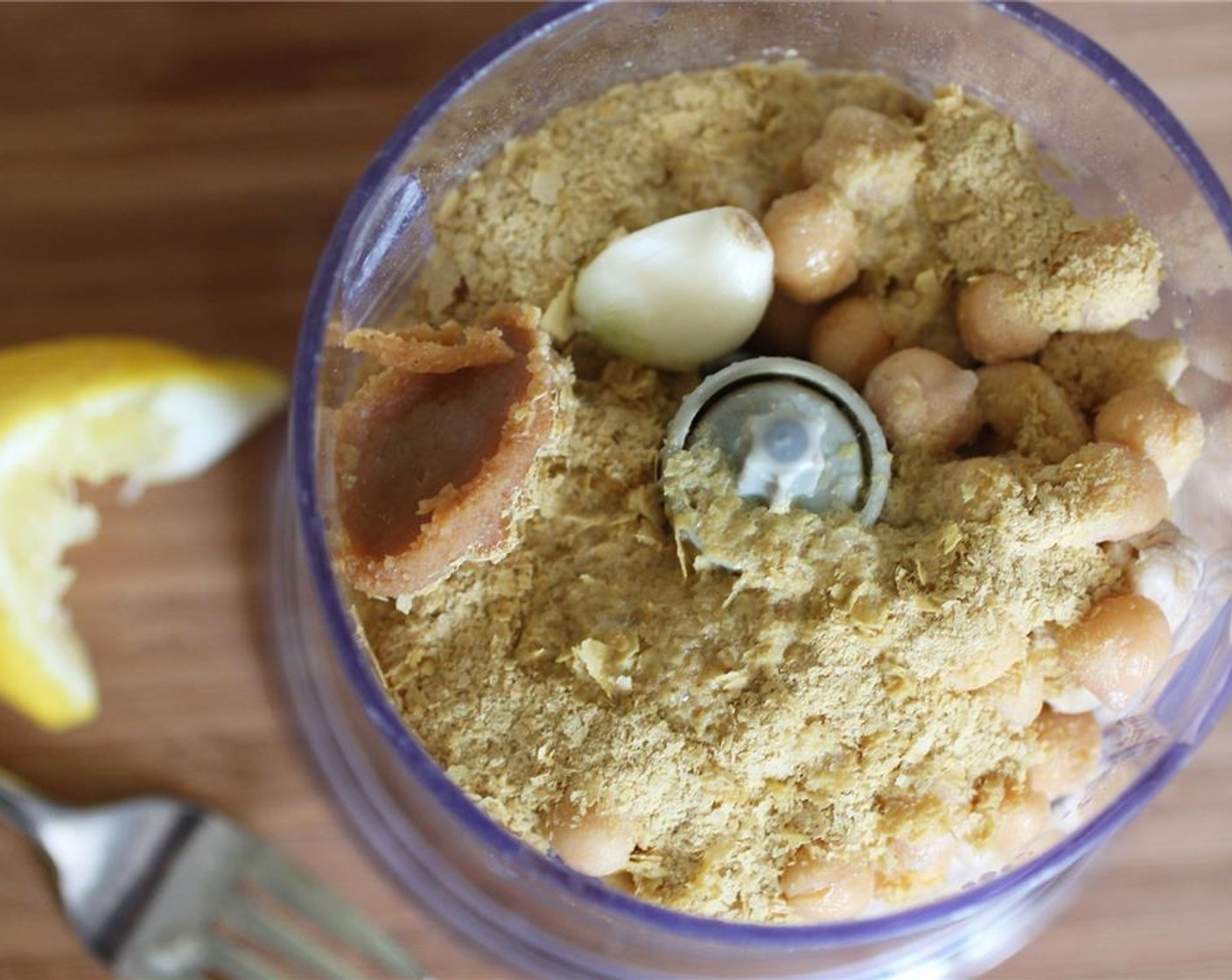 step 3 Combine the soaked Cashew Nuts,Lemon (1/4), Garlic (1 clove), Canned Chickpeas (1/3 cup), Nutritional Yeast (4 Tbsp), and White Miso Paste (1 tsp) in a food processor.