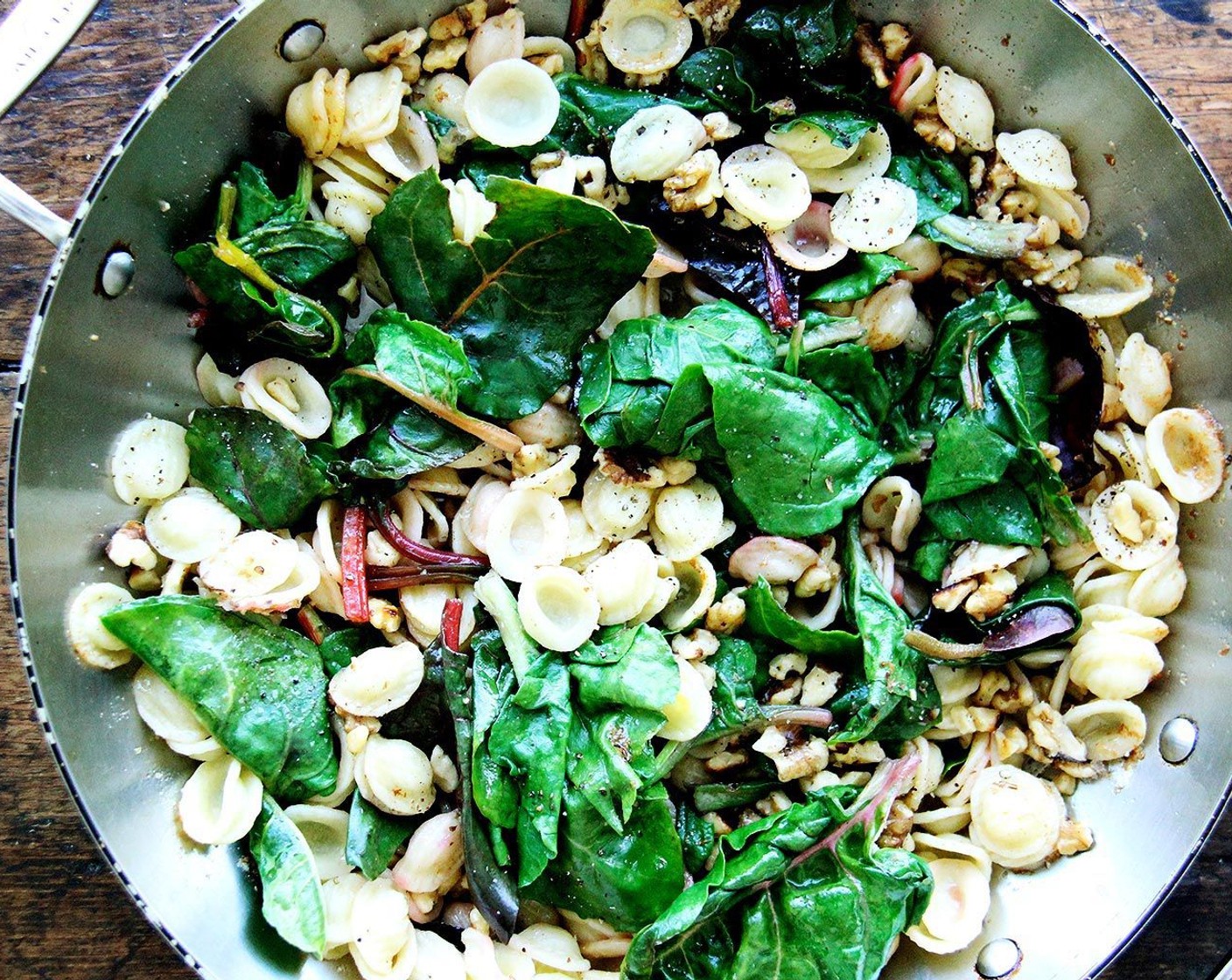 step 7 Bring the brown butter back up to temperature over medium or medium-high heat; add the pasta and greens to the pan. Add the walnuts and toss to coat. Sprinkle Pecorino Romano Cheese (4 Tbsp) over top and toss again. Taste. Add more Salt (to taste) and Freshly Ground Black Pepper (to taste). If necessary add some of the pasta cooking liquid to the pan.
