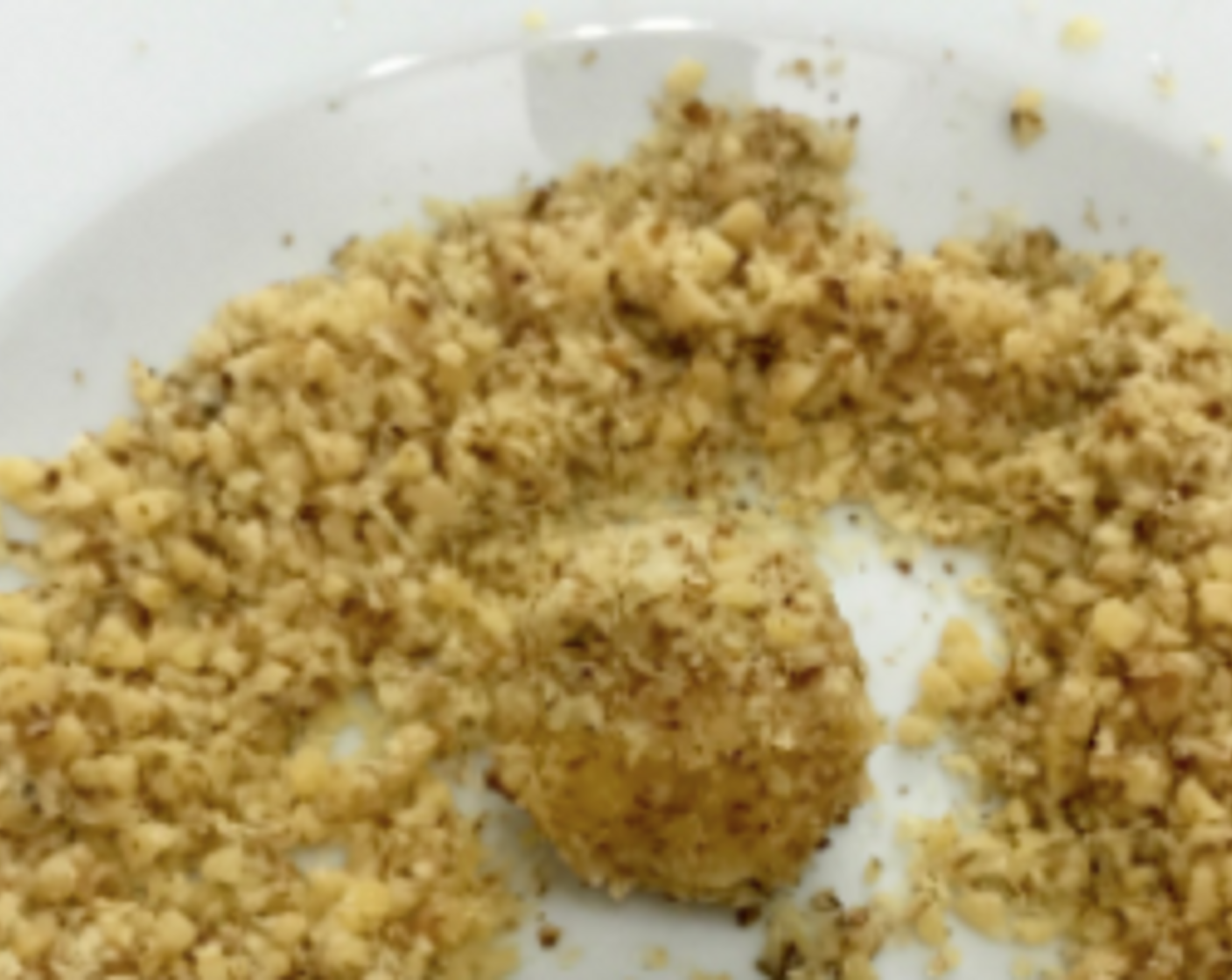 step 21 Next, roll the glued ball in the chopped walnut, to cover them so that the nuts will stick to the dough.