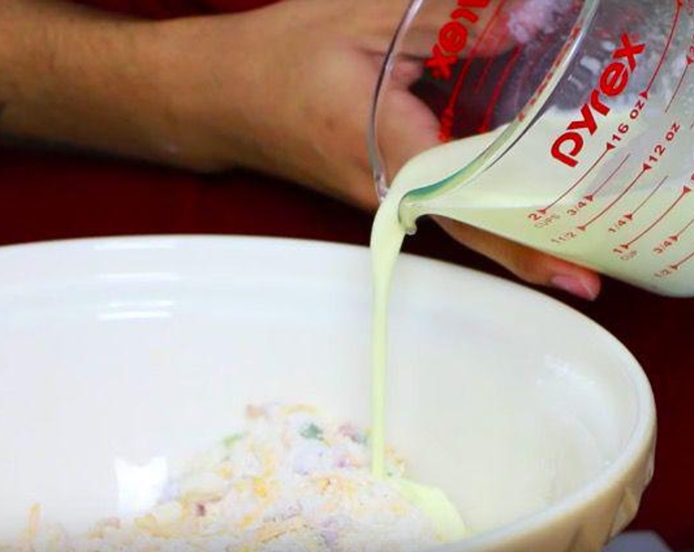 step 2 Take a jug and add Heavy Cream (1/2 cup), Large Egg (1) and mix with a fork. Pour it into the dry ingredients and mix it with hands.