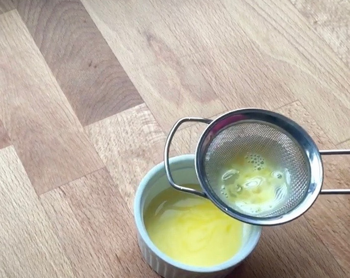 step 19 While mooncakes are in the oven, prepare egg wash. Mix Egg (1) Yolk and Water (1 Tbsp), then strain through a fine sieve.