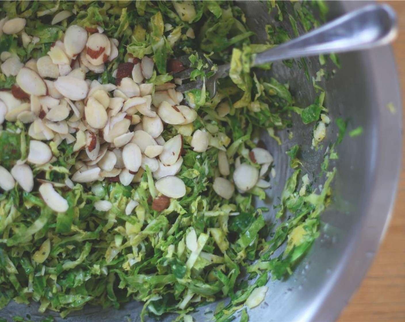 step 6 Toss the shredded sprouts in the dressing and add the remaining chopped mint and Slivered Almonds (4 Tbsp).