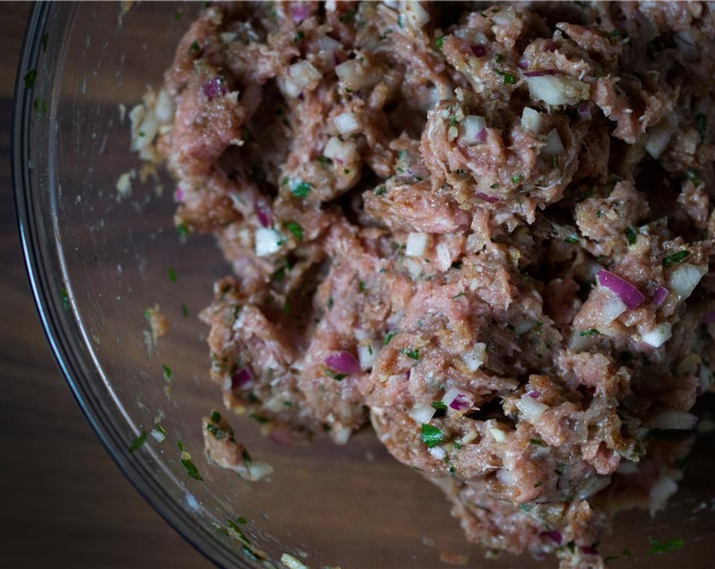 step 2 In a large bowl, mix all ingredients for the meatballs Ground Lamb (1.5 lb), Bulgur Wheat (2 Tbsp), Garlic (2 cloves), Red Onion (1), Kosher Salt (1 tsp), Ground Black Pepper (1/2 tsp), Egg (1), Ground Cumin (1 tsp), Paprika (1 tsp), Ground Cinnamon (1/2 tsp), Italian Flat-Leaf Parsley (2 Tbsp) until well incorporated – hands work best for this. Cover and refrigerate for 30 minutes and up to 24 hours.