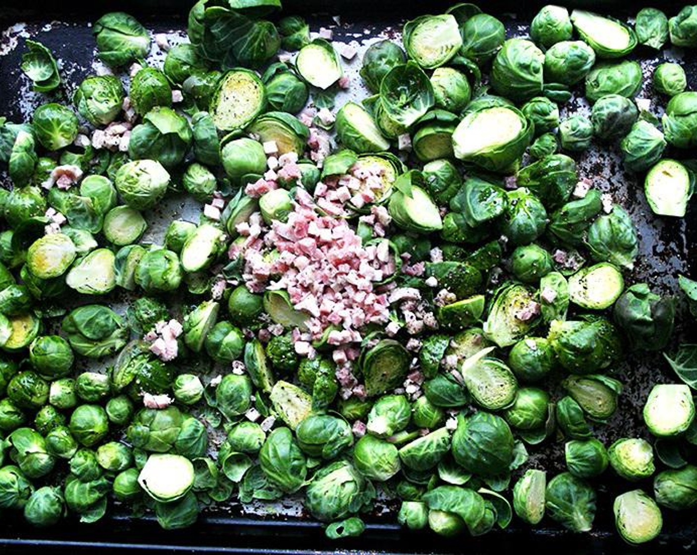 step 2 Place the Brussels Sprouts (5 cups) on a baking sheet, including any of the loose leaves. Cut the Pancetta (1/2 cup) into 1/2-inch dices and add to the pan. Add the Olive Oil (4 Tbsp), the Kosher Salt (1/2 tsp) and Freshly Ground Black Pepper (1/2 tsp) and toss with your hands. Spread out the mixture in a single layer.