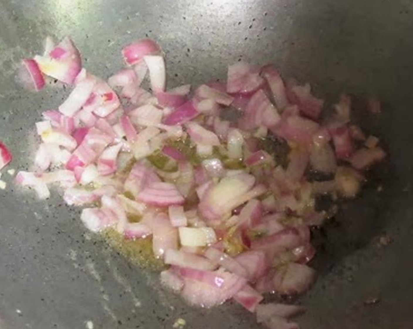 step 3 Heat Olive Oil (2 tsp) in a pan and add garlic and onion. Cook for a minute on high or until they are translucent.