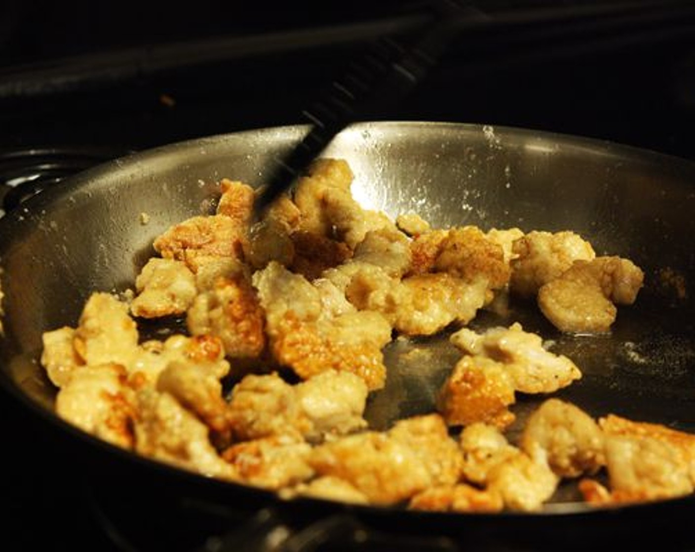 step 6 Heat Vegetable Oil (4 Tbsp) in a large skillet over medium heat. Once hot, add the chicken pieces to the pan. Toss the chicken as it cooks, making sure that all sides of the pieces are crispy. Cook for 10-15 minutes until golden and crispy.