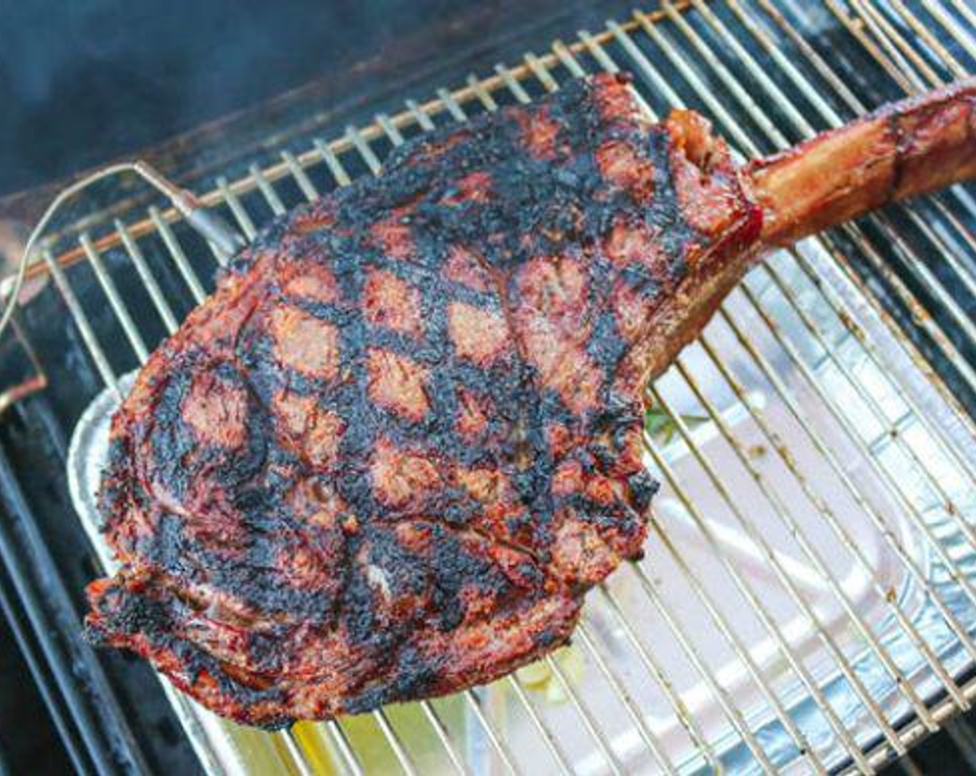 step 4 Place a shallow aluminum pan directly under the steak and add Butter (1/2 cup), Garlic (1 head), Fresh Rosemary (1 bunch), Fresh Thyme (1 bunch) and Olive Oil (4 Tbsp).