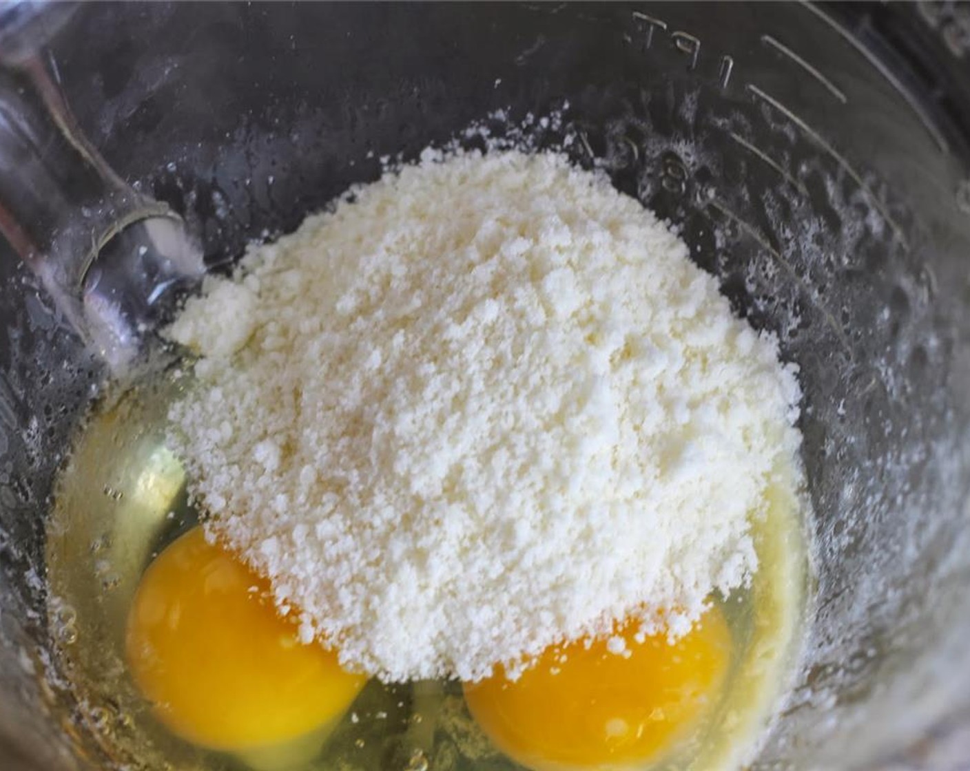step 3 In a separate bowl, whisk Large Eggs (2). Add Grated Parmesan Cheese (1/2 cup) and mix well.