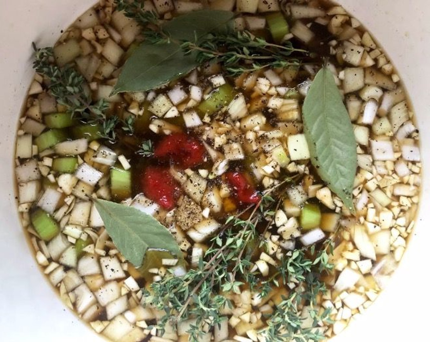 step 2 Add Fresh Thyme (4 sprigs) and Bay Leaves (3), then dollop Tomato Paste (4 Tbsp) on top.