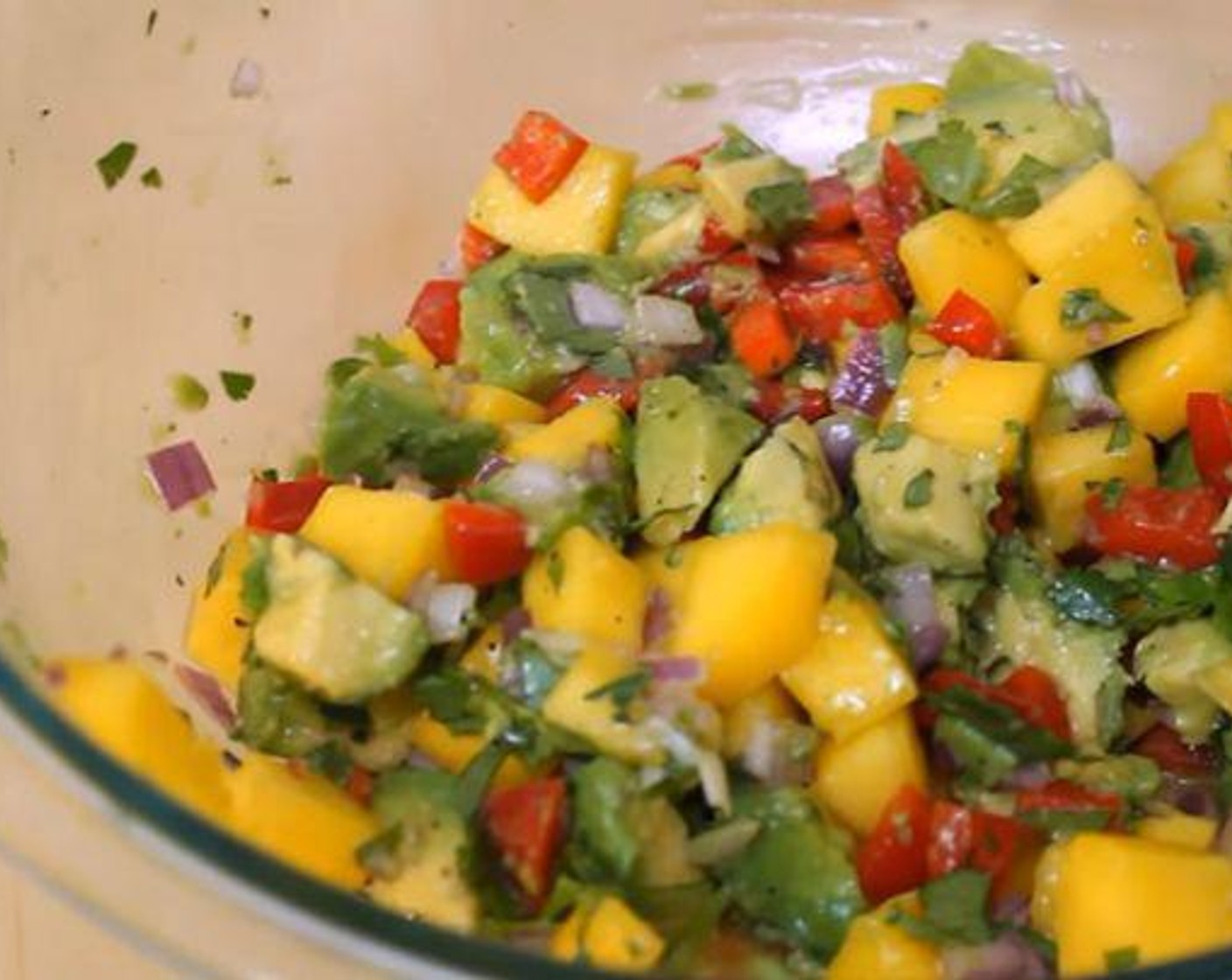 step 2 In a different bowl, add the Mango (1), Red Bell Pepper (1/3 cup), Red Onions (4 Tbsp), Avocado (1), Jalapeño Peppers (to taste) and Fresh Cilantro (4 Tbsp). Juice the Limes (2) over the top and add the Salt (1/2 tsp) and Ground Black Pepper (to taste). Mix thoroughly.