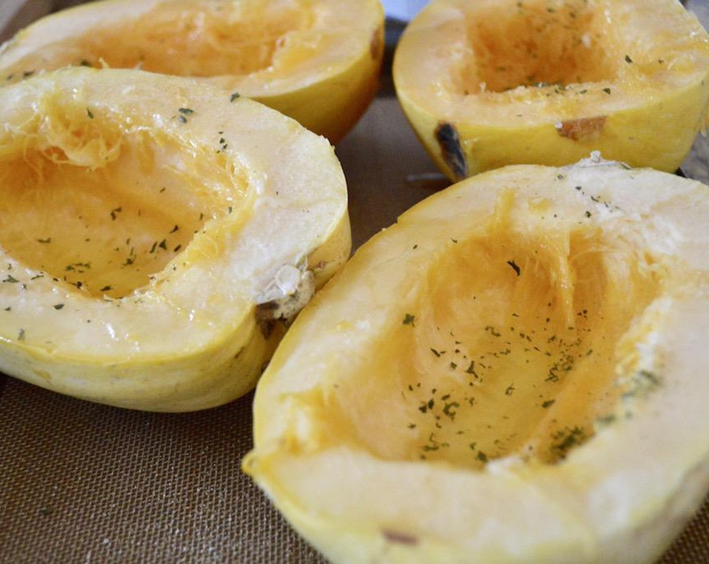 step 2 Cut each of the Spaghetti Squash (2) in half lengthwise to form 4 little boats. Scrape the seeds out of each half. Drizzle the flesh in each half generously with Olive Oil (as needed), followed by Salt (to taste), Ground Black Pepper (to taste), Garlic Powder (to taste), and Dried Parsley (to taste). Roast the squash for 45 minutes to make it tender and shreddable.